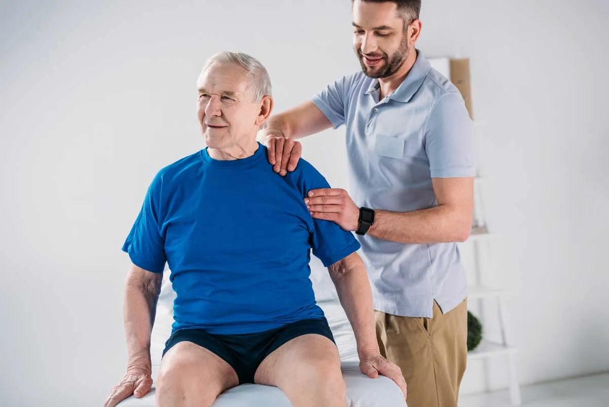 portrait of physiotherapist doing massage to senio 2023 11 27 05 05 46 utc